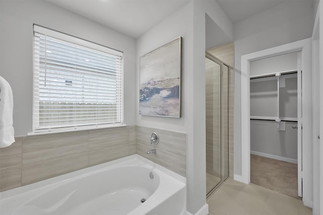 bathroom featuring tile patterned floors and separate shower and tub