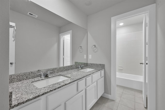 bathroom featuring tile patterned floors, vanity, and washtub / shower combination