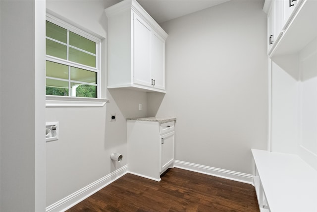 laundry area with hookup for an electric dryer, dark hardwood / wood-style floors, cabinets, and hookup for a washing machine