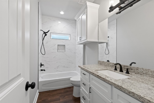 full bathroom featuring vanity, toilet, wood-type flooring, and tiled shower / bath