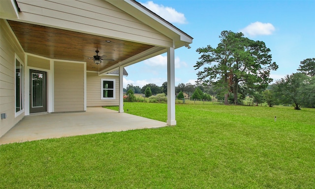 view of yard with a patio and ceiling fan