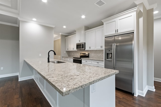 kitchen featuring appliances with stainless steel finishes, white cabinetry, dark wood-type flooring, and sink