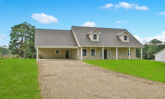 new england style home featuring a porch, a carport, and a front lawn