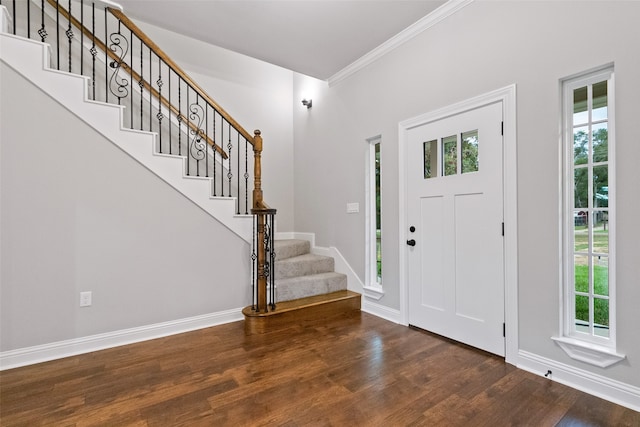 foyer entrance featuring crown molding and dark hardwood / wood-style flooring