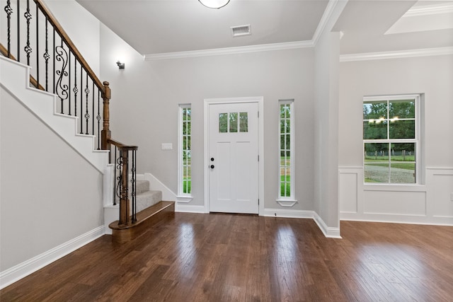 entrance foyer featuring dark hardwood / wood-style flooring and ornamental molding