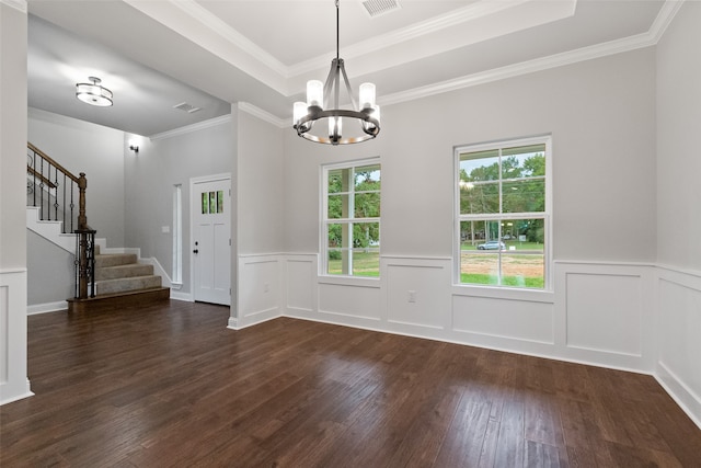 interior space featuring a tray ceiling, ornamental molding, dark wood-type flooring, and an inviting chandelier