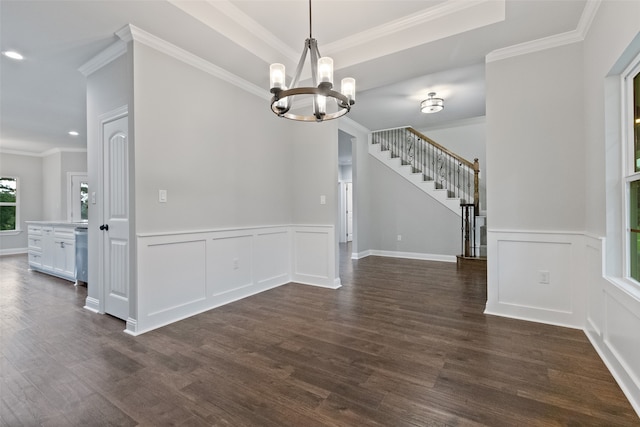 unfurnished dining area with crown molding, dark wood-type flooring, and an inviting chandelier