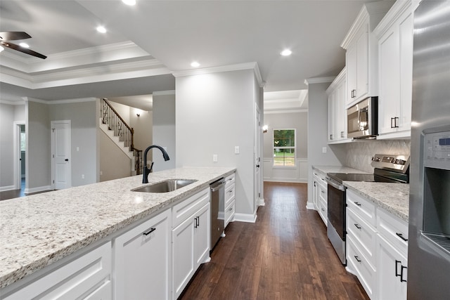 kitchen featuring white cabinetry, sink, stainless steel appliances, and ornamental molding