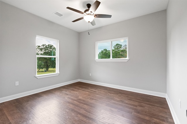 unfurnished room with ceiling fan, dark hardwood / wood-style flooring, and a healthy amount of sunlight