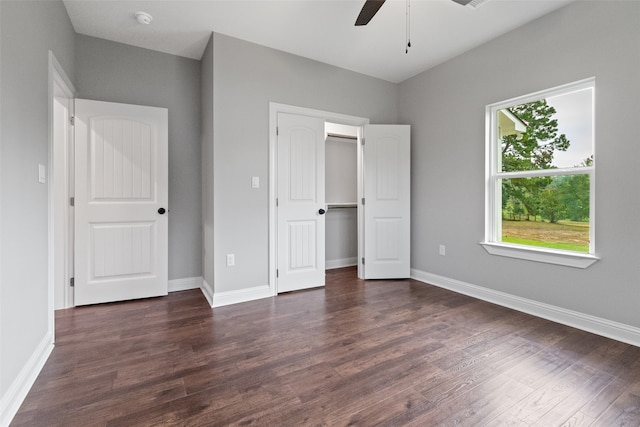 unfurnished bedroom featuring ceiling fan, dark hardwood / wood-style flooring, and a closet