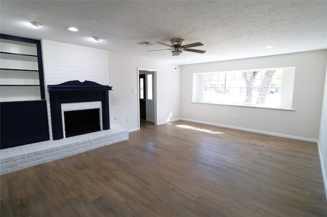 unfurnished living room featuring a textured ceiling, dark hardwood / wood-style flooring, and a fireplace