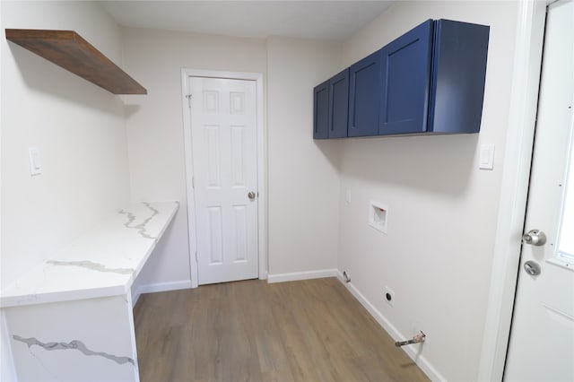 clothes washing area featuring electric dryer hookup, wood-type flooring, cabinets, and washer hookup