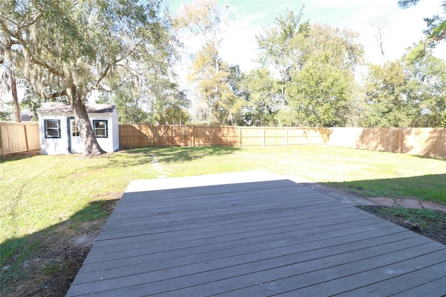 deck featuring a storage unit and a yard