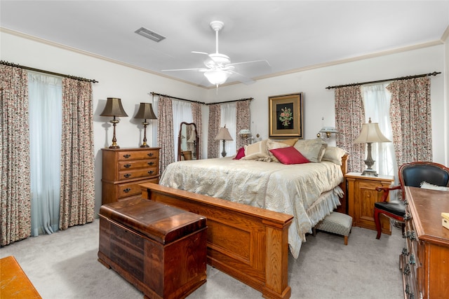 carpeted bedroom featuring ceiling fan and ornamental molding