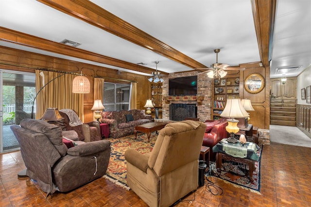 living room with beam ceiling, ceiling fan, dark parquet floors, wood walls, and a fireplace