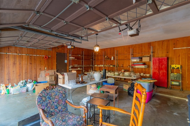 garage with wooden walls and a garage door opener