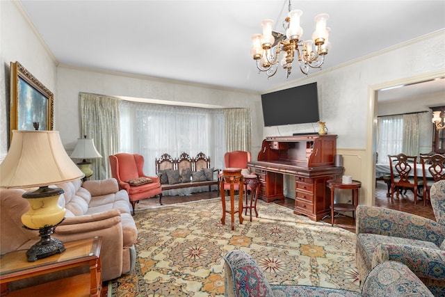 living room with hardwood / wood-style floors, ornamental molding, and an inviting chandelier