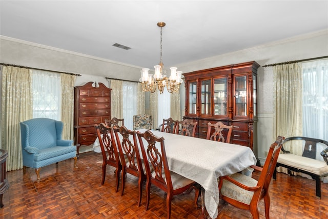 dining room with a chandelier, a wealth of natural light, and ornamental molding