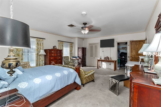 bedroom with ceiling fan, ornamental molding, and light carpet