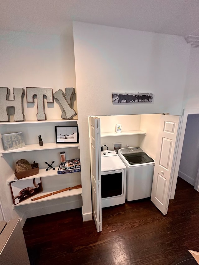 washroom featuring dark hardwood / wood-style floors and washing machine and clothes dryer