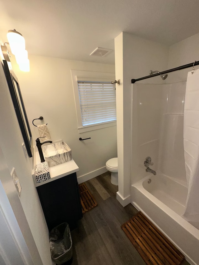 full bathroom with vanity, toilet, washtub / shower combination, and hardwood / wood-style flooring