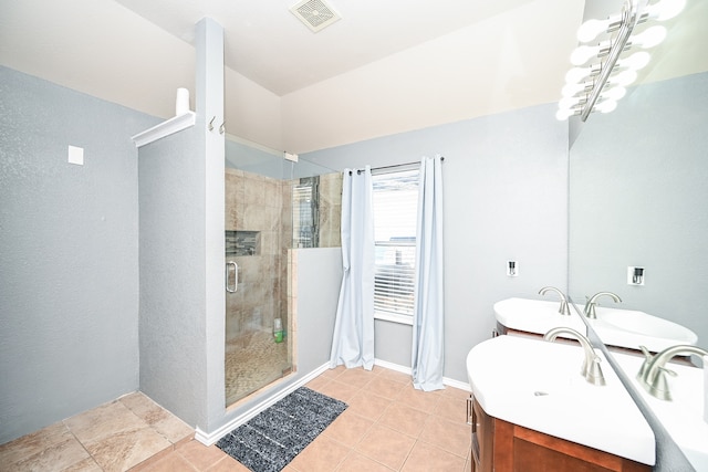 bathroom with vanity, tile patterned floors, an enclosed shower, and a notable chandelier