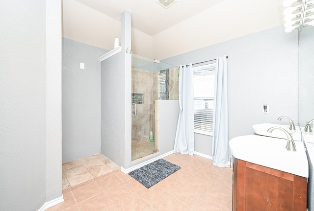 bathroom with tile patterned flooring, vanity, and an enclosed shower