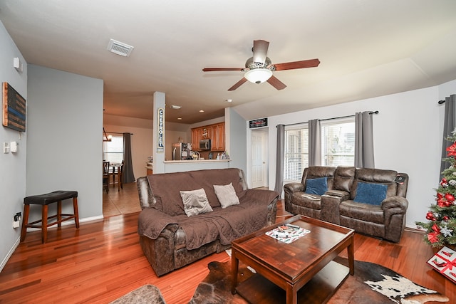 living room with ceiling fan and light hardwood / wood-style flooring