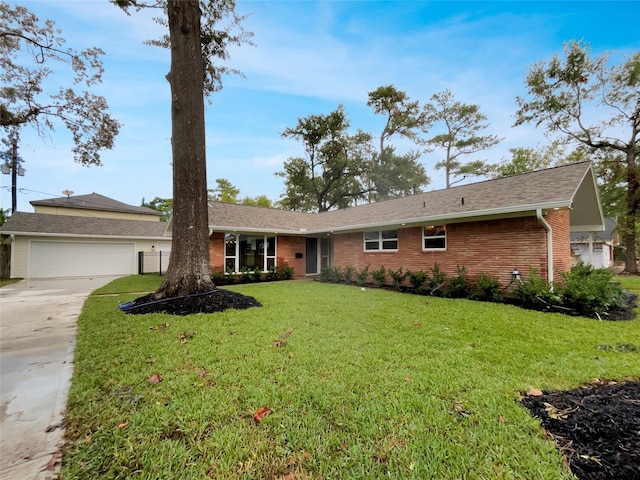 single story home with a front yard and a garage