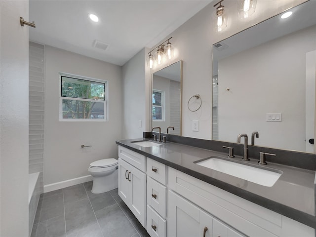 bathroom with tile patterned flooring, vanity, and toilet