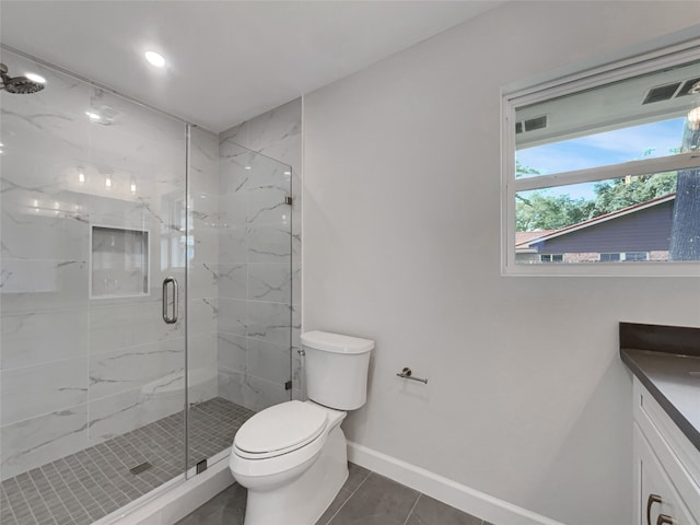 bathroom with tile patterned flooring, vanity, toilet, and walk in shower