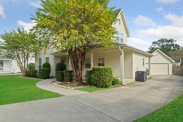 view of front facade featuring central AC unit, a garage, and a front lawn