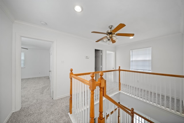 hallway featuring ornamental molding and light carpet