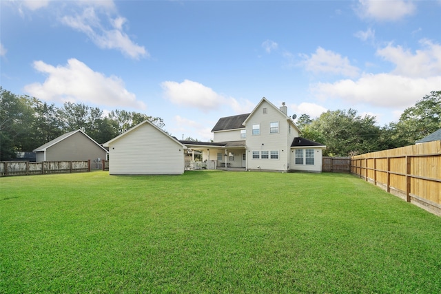 rear view of house with a yard