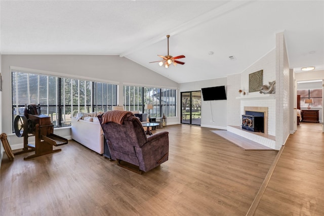 living area featuring light wood-style flooring, high vaulted ceiling, beam ceiling, baseboards, and ceiling fan
