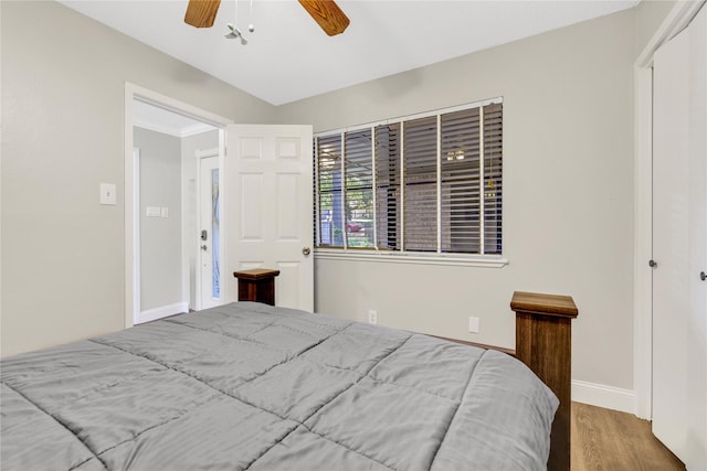 bedroom with wood finished floors, baseboards, and ceiling fan