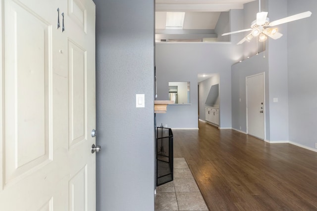 interior space featuring hardwood / wood-style flooring, high vaulted ceiling, and ceiling fan