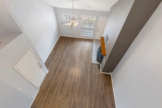 unfurnished living room featuring dark hardwood / wood-style floors and ceiling fan