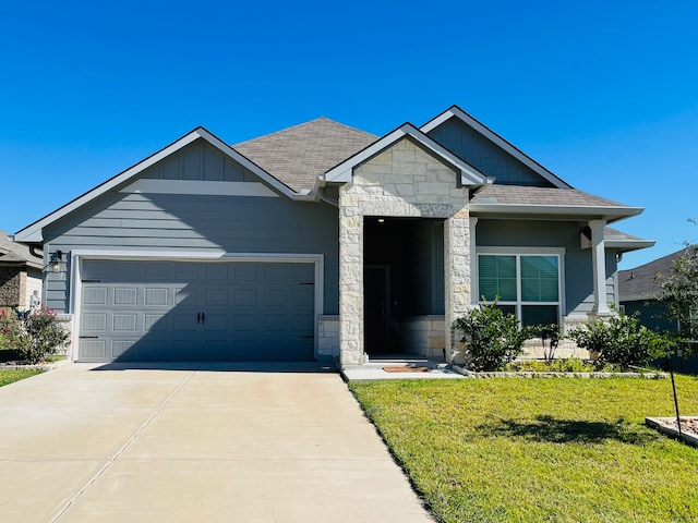 view of front of house with a front yard and a garage