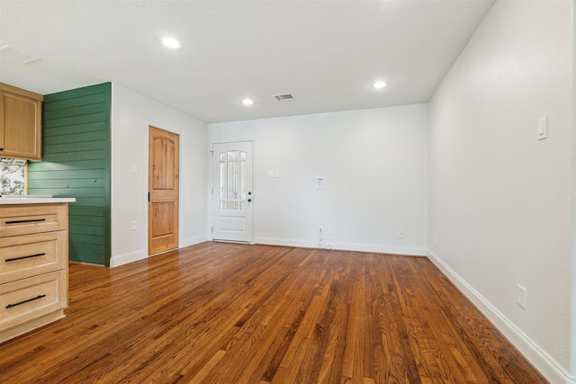 unfurnished living room with dark hardwood / wood-style flooring