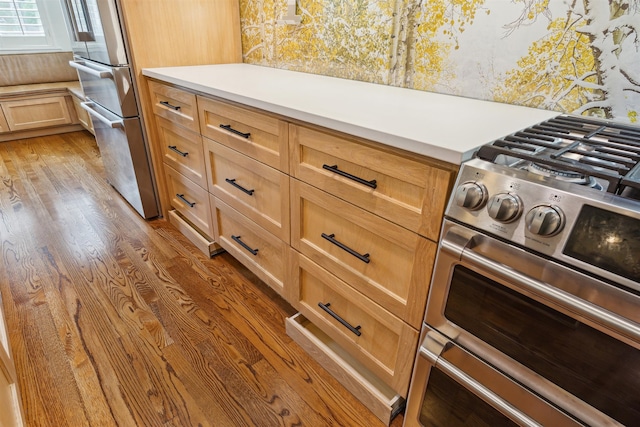 kitchen featuring dark hardwood / wood-style flooring and high end stainless steel range