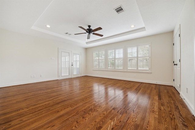 interior space featuring french doors, dark hardwood / wood-style flooring, a tray ceiling, and ceiling fan