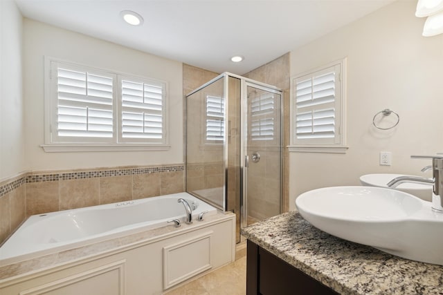 bathroom featuring tile patterned floors, separate shower and tub, and sink