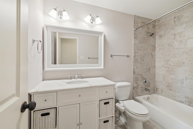 full bathroom with toilet, vanity, and tiled shower / bath