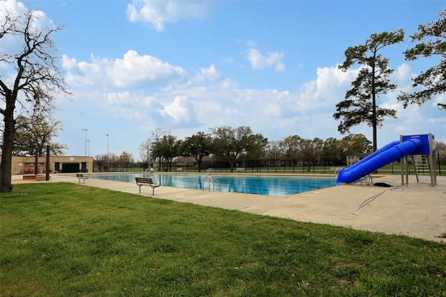 view of pool featuring a lawn