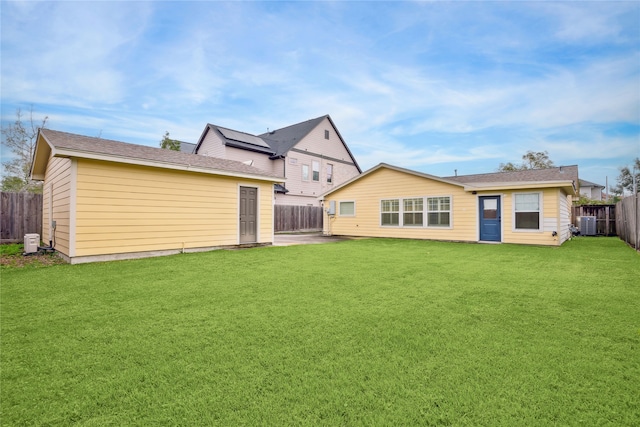 rear view of property featuring a lawn