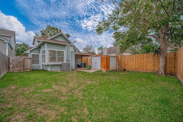 back of property with a lawn, a shed, and central AC unit