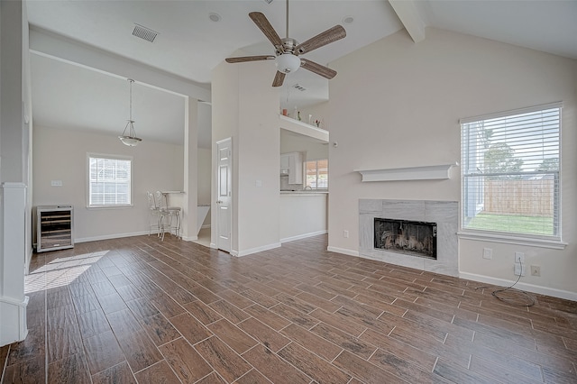 unfurnished living room featuring hardwood / wood-style floors, ceiling fan, and a healthy amount of sunlight