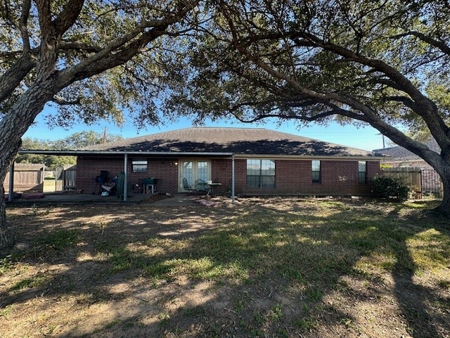 back of house with a lawn