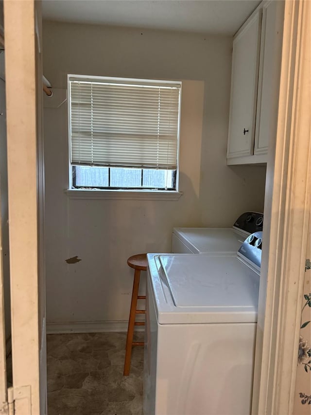 laundry room with cabinets and washer and clothes dryer